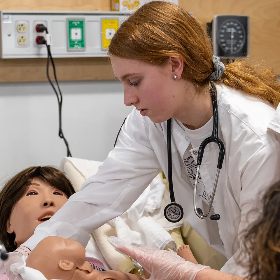 BW nursing student with birth simulator